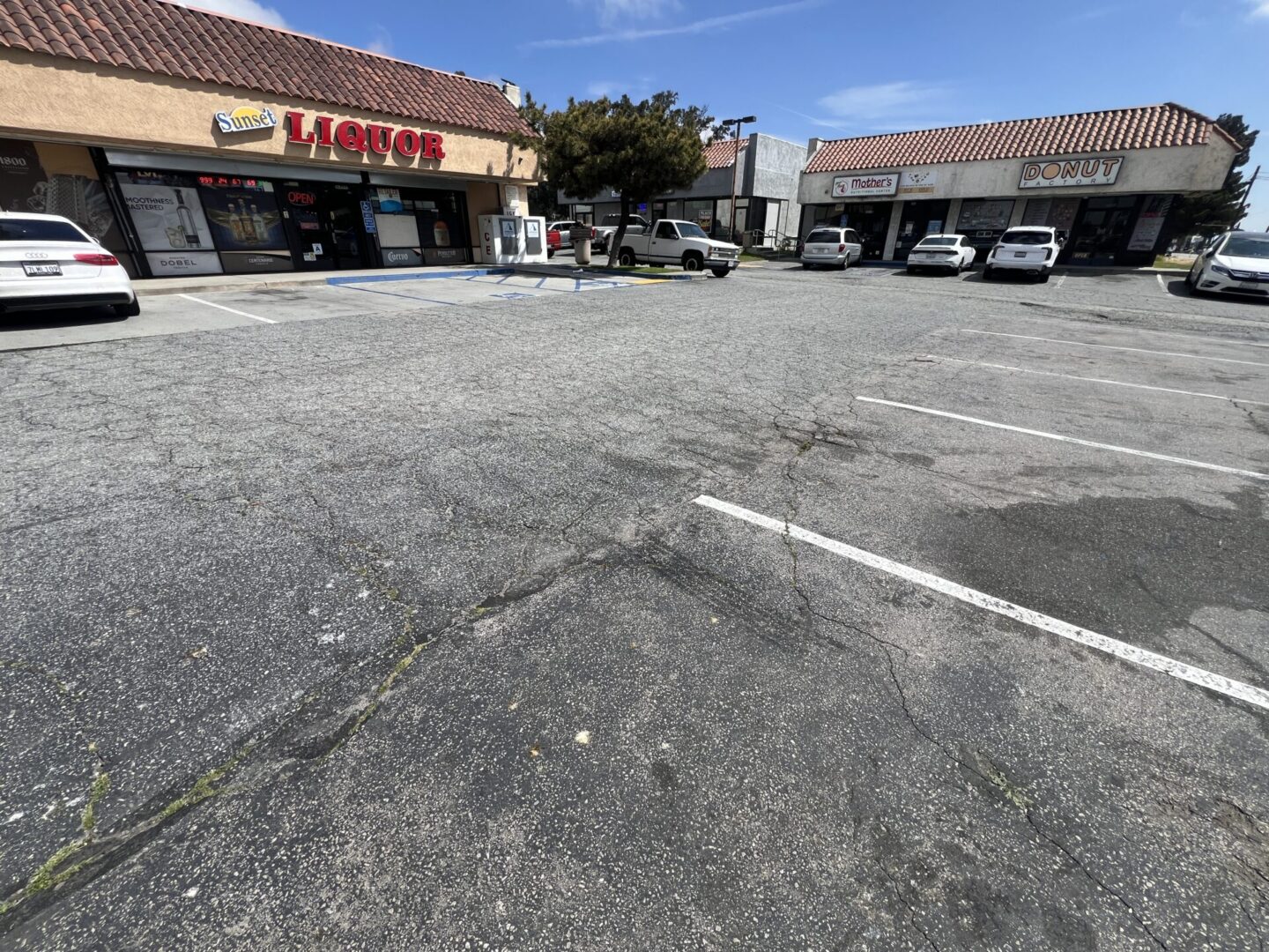 Some cars parked outside some stores